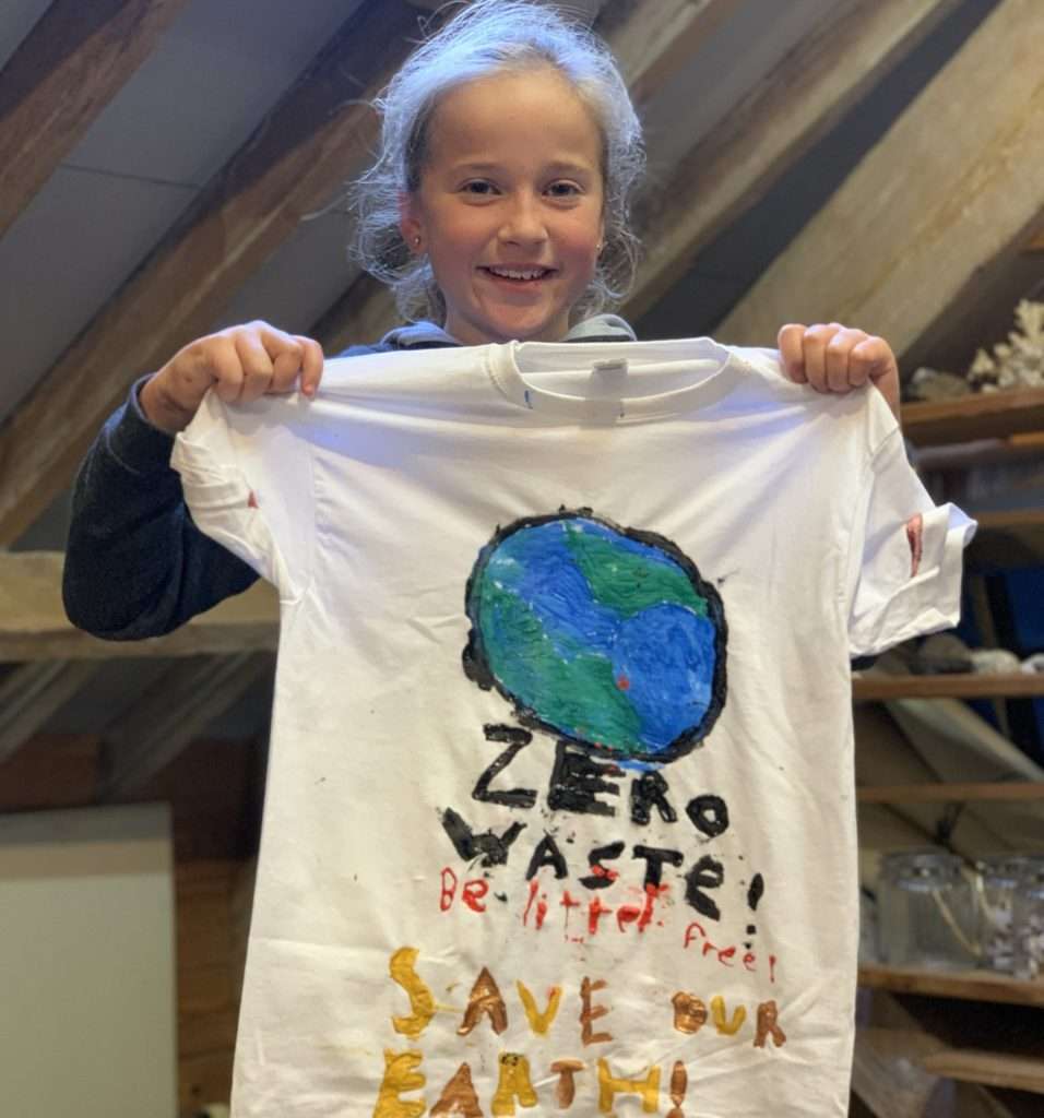 Young girl holding a t-shirt she designed
